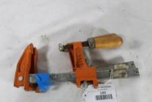 Two small adjustable clamps. Used.