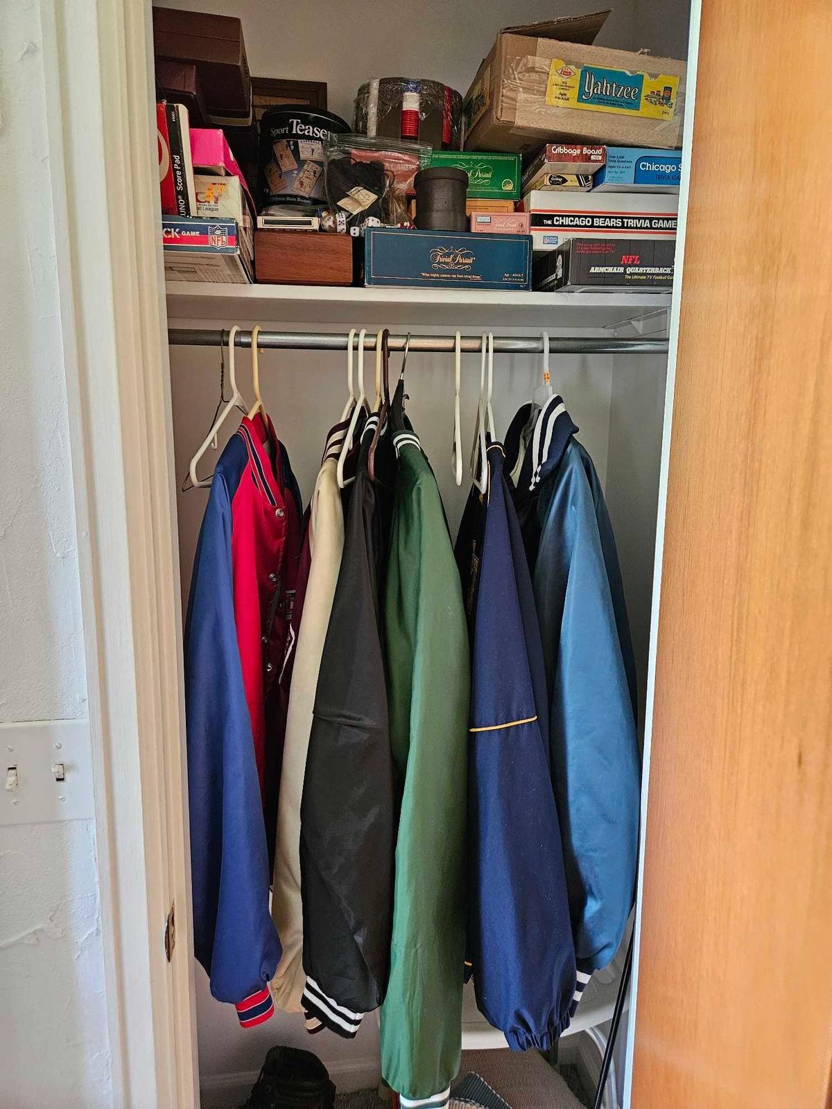 Contents of closet including games and Coats.