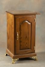Decorative oak single door Slot Machine Stand on brass feet, measures 34" T x 17 1/4" W x 17 1/4" D