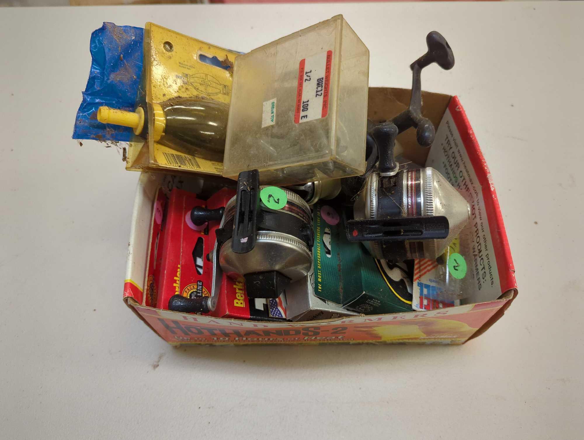 Box of fishing, reels, weights, and other fishing accessories. Comes as is shown in photos. Appears