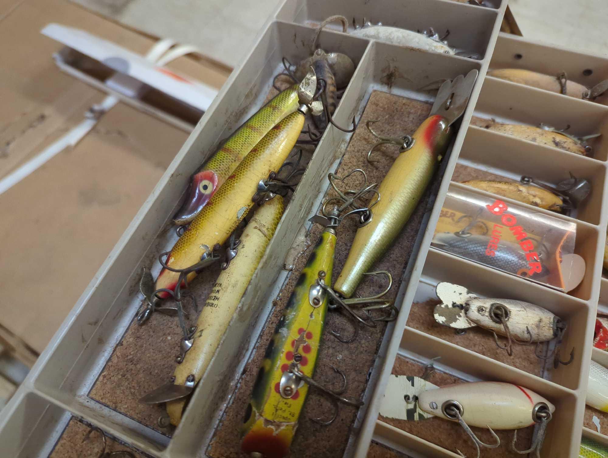 Large tackle box and contents including various fishing lures of similar style. Comes as is shown in