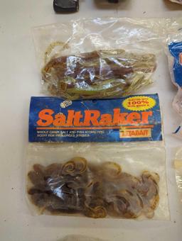 Bag of fishing worm lures and fishing reel. Comes as is shown in photos. Appears to be used.