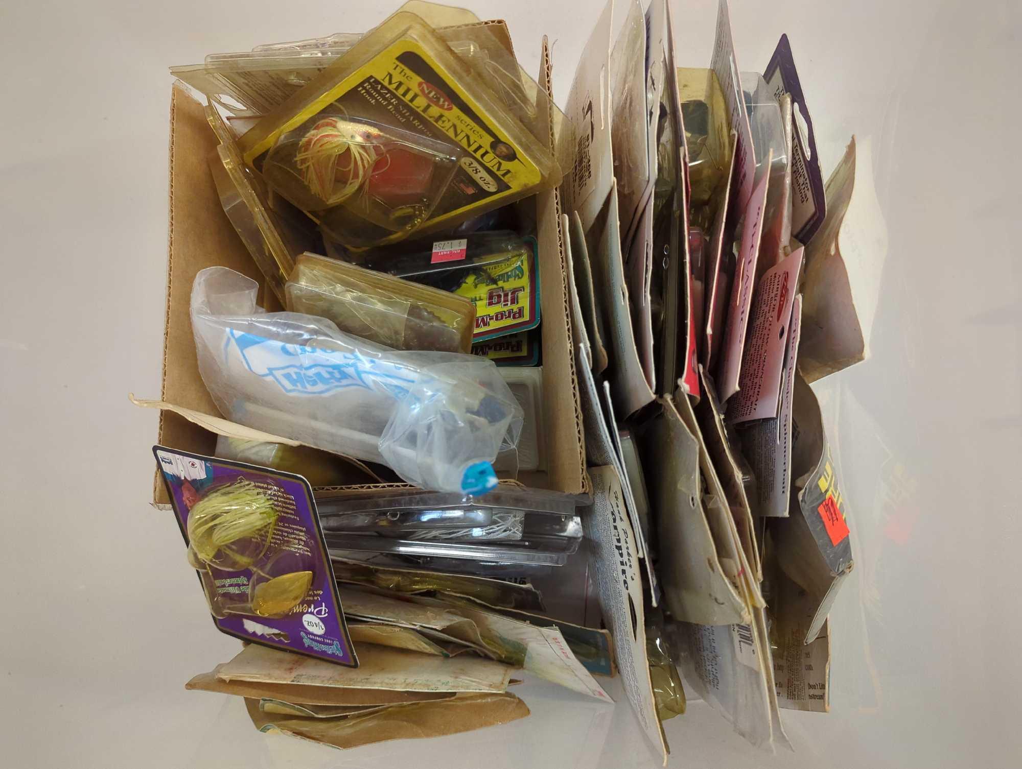 Clear organizer tote and contents including various fishing lures and other fishing accessories.