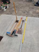 Group of assorted yard tools, tamper, post hole digger and more