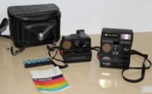Two Polaroid Cameras with One Case, Manual, and Flash Unit