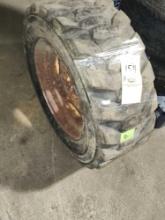 Tires; (1) 10-16.5 NHS skid steer tire on wheel.